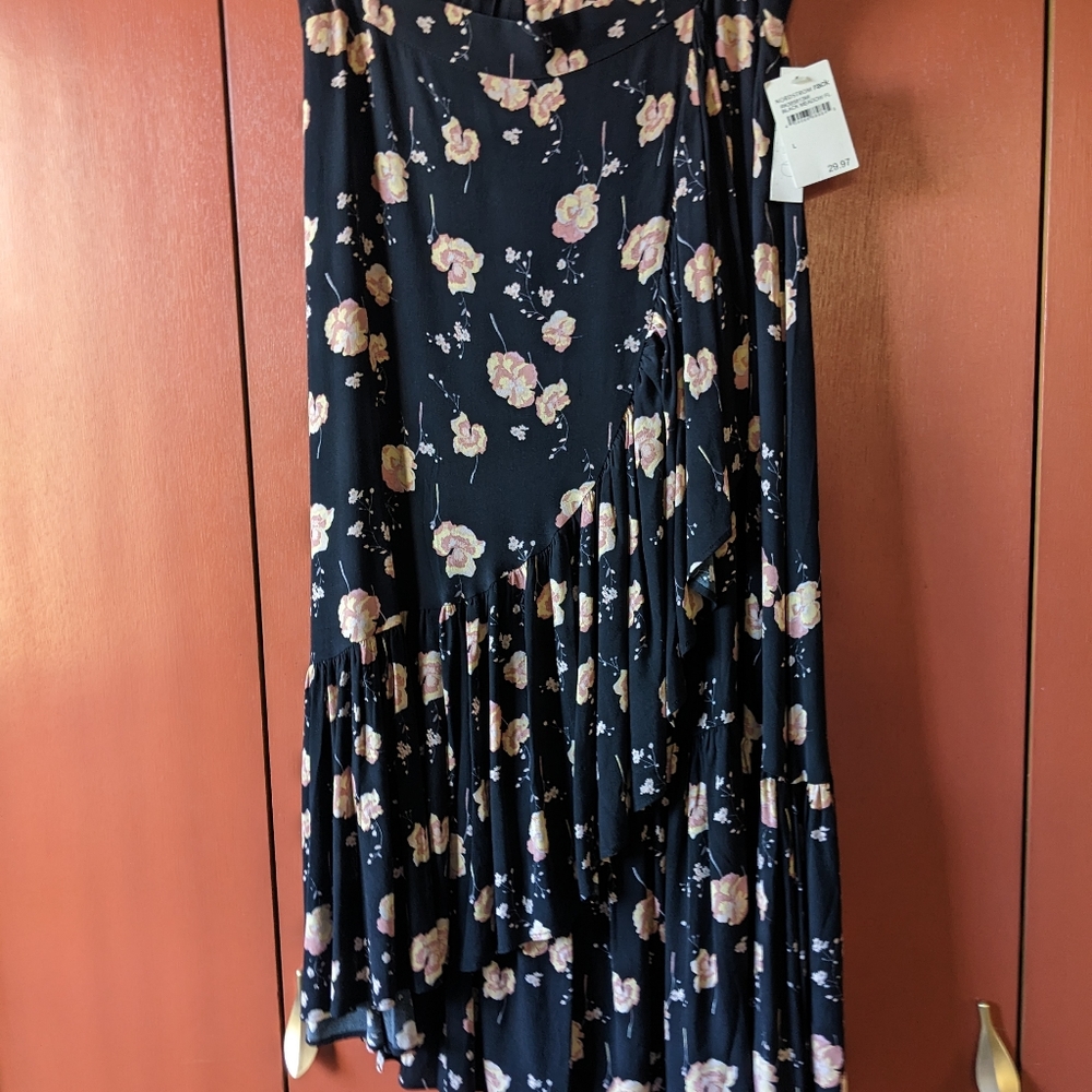 Ruffle bottom elastic waist skirt with pink floral pattern on black. Size large.